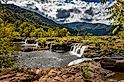 Sandstone Falls on the New River at New River Gorge National Park and Preserve during the Autumn leaf color change near Hinton, West Virginia.