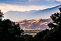 Scenic view of desert against cloudy sky at Great Sand Dunes National Park during sunset