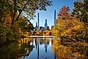 Central Park in Autumn with view of Billionaires' Row skyscrapers from The Lake. Manhattan, New York City