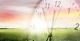 Clock, grass and sky. Spring time