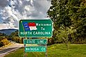 A Welcome to North Carolina sign on the highway marking the state border with Tennessee.