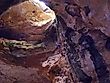 Entering the Natural Trap Cave — a large cave/hole that trapped falling prehistoric animals, located in the Bighorn Mountains foothills of Big Horn County, Wyoming. Editorial credit: Bureau of Land Management, Public domain, via Wikimedia Commons