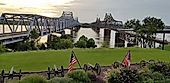 Two bridges crossing the Mississippi River contrasting old and new, railroad and highway, and train and road in Vicksburg, Mississippi