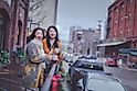 Happy asian elderly mother and adult daughter enjoying coffee at Portland pearl district outdoor cafe