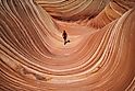 Girl hikes through the wave sandstone in coyote buttes, Arizona