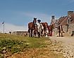 Reenactors leading horses through Fort Ticonderoga after a re-enactment