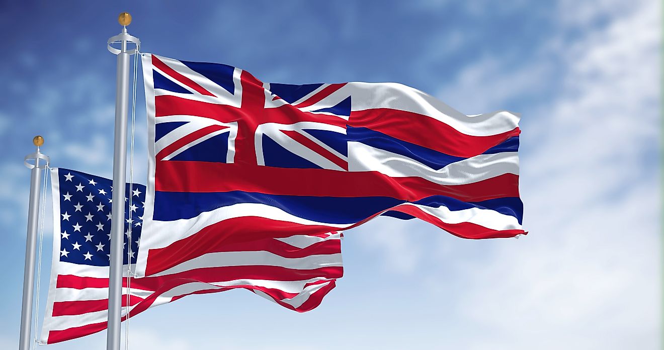 The Hawaii state flag waving along with the national flag of the United States of America