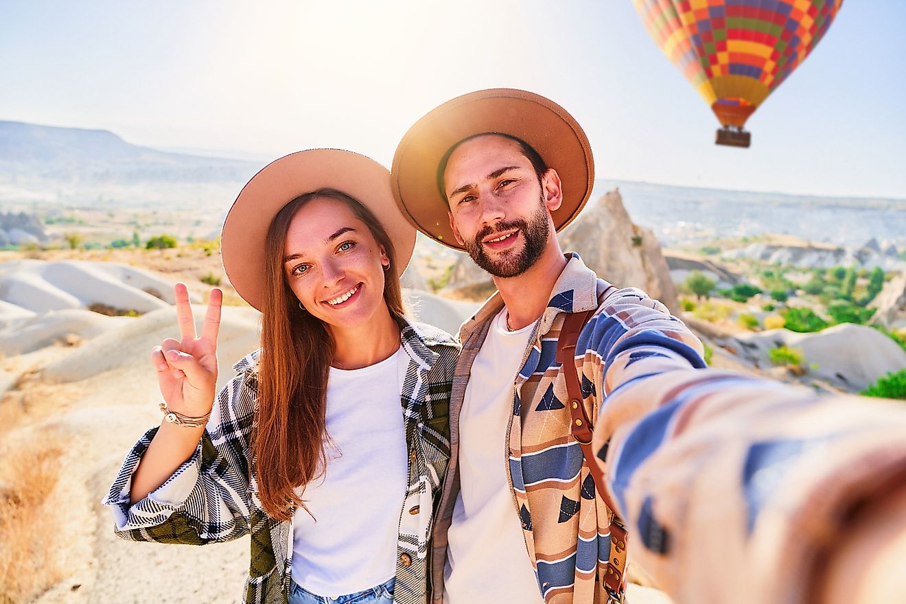Happy smiling joyful traveling couple takes selfie