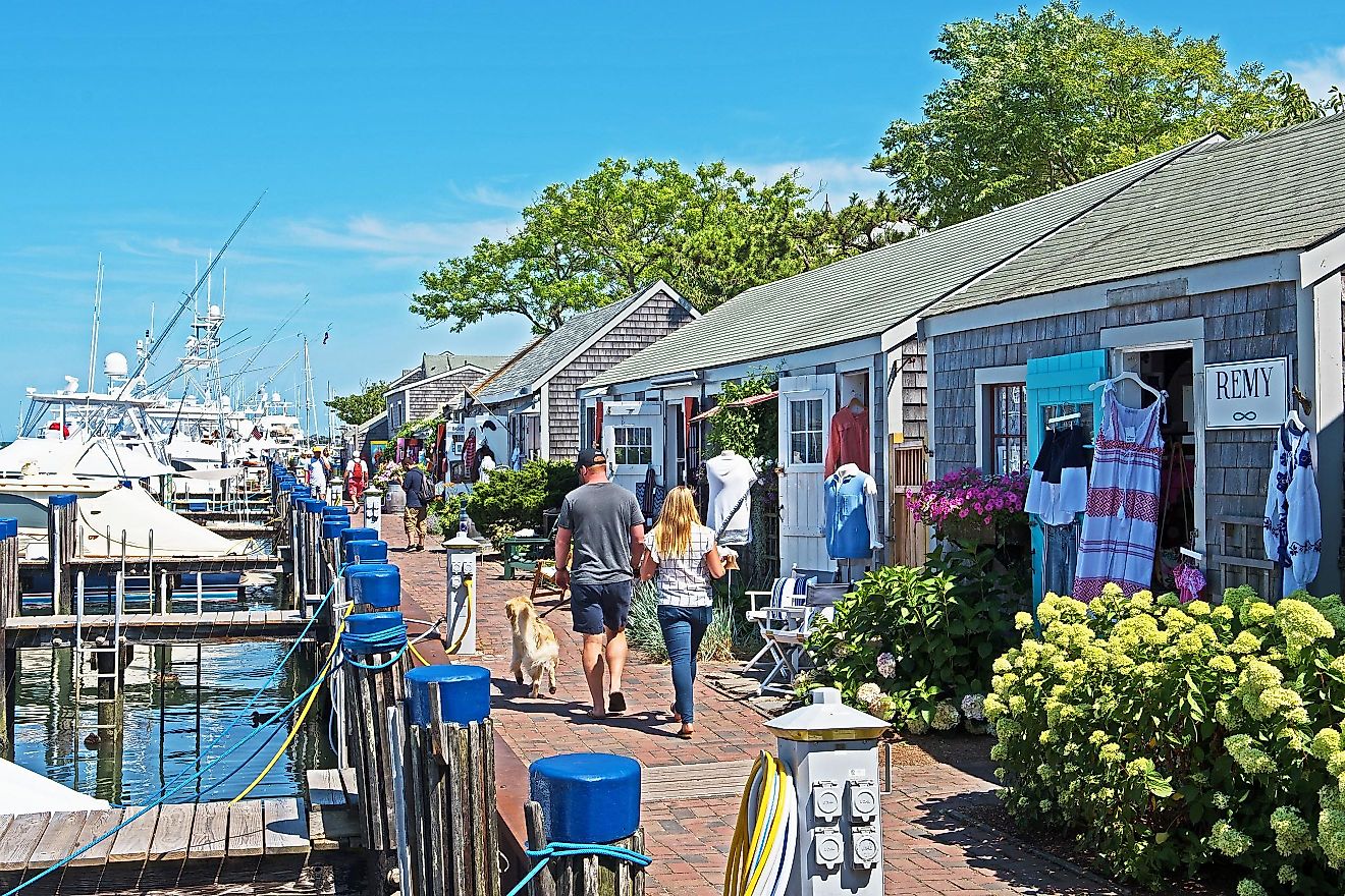 a row of eclectic stores can be found next to the harbor in Nantucket.