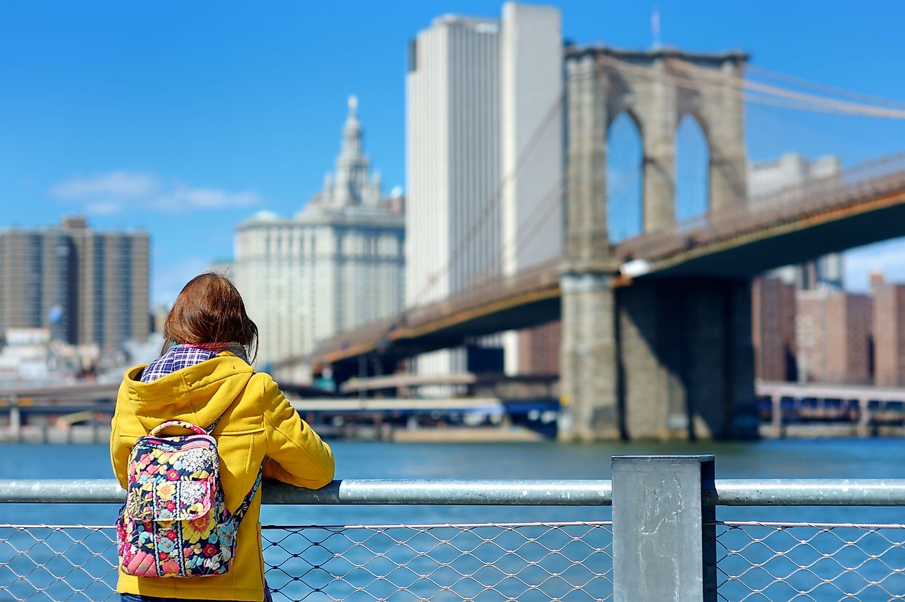 Young woman sightseeing at the Brooklyn Bridge, New York.