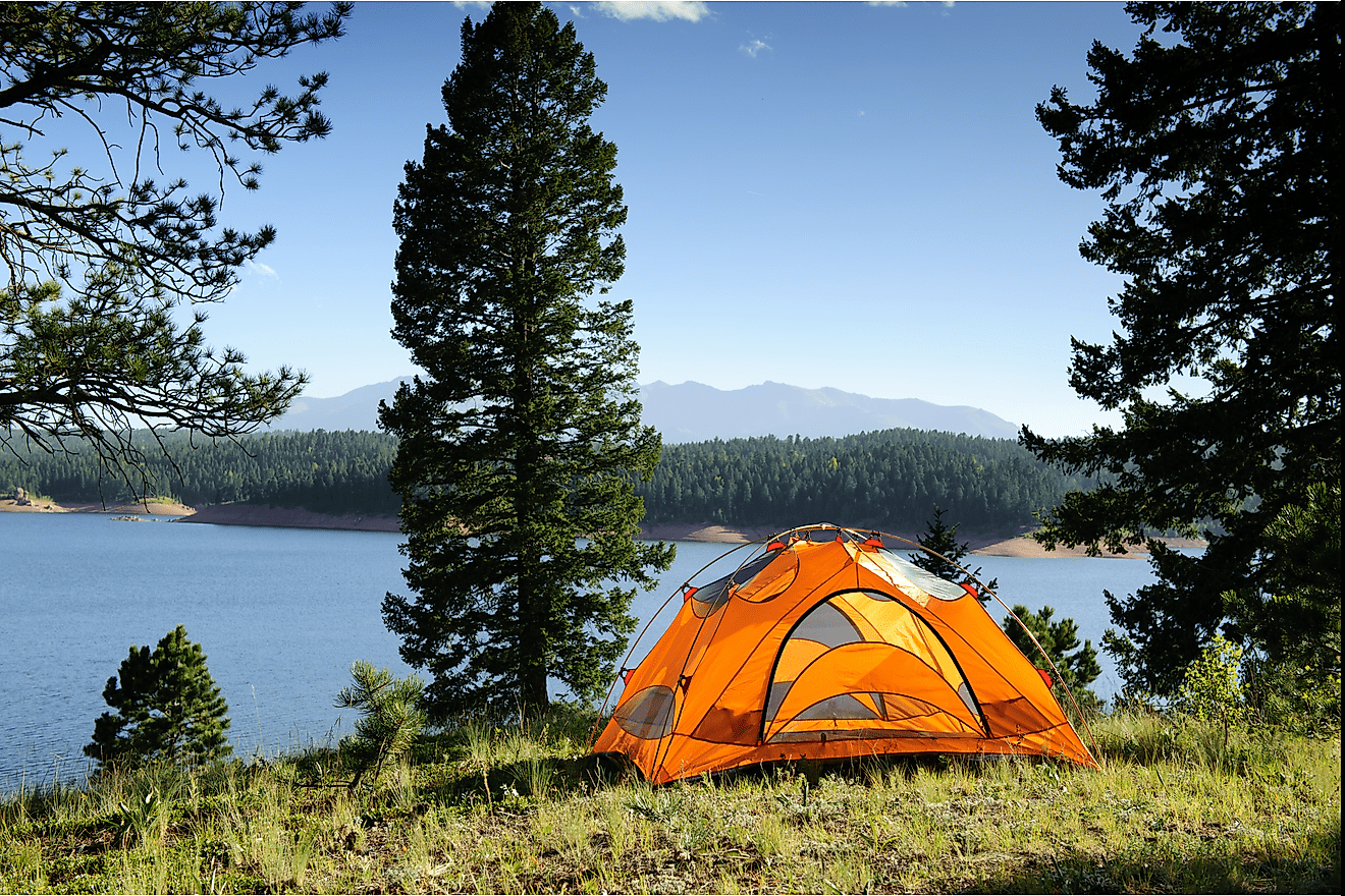 Camping tent by mountain lake