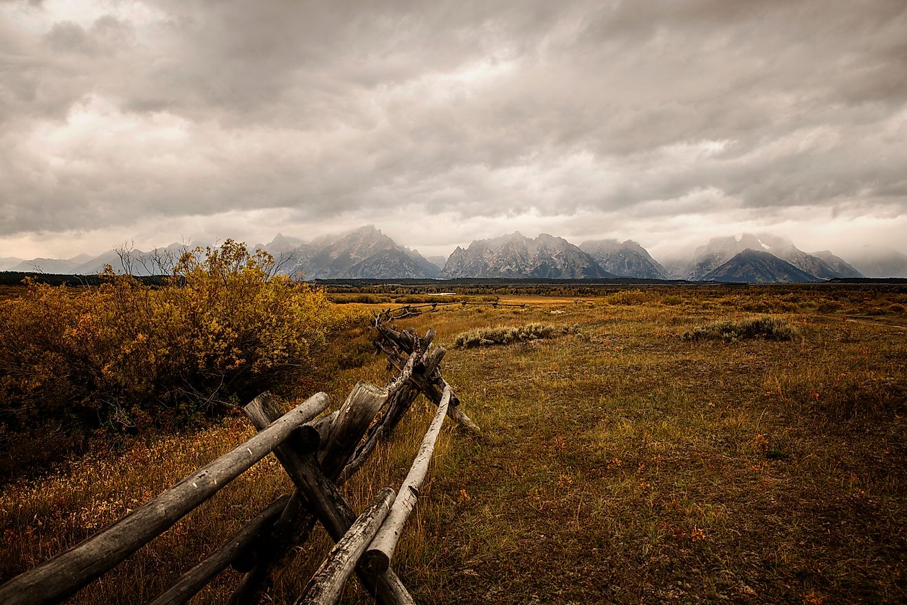 Cloudy fall morning view of the Tetons along a rustic fence