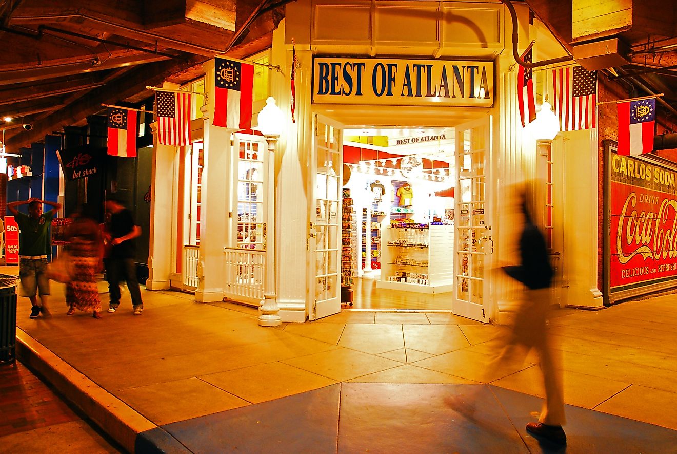 A man walks in front of a souvenir store in the Underground Atlanta shopping area. Editorial credit: James Kirkikis / Shutterstock.com