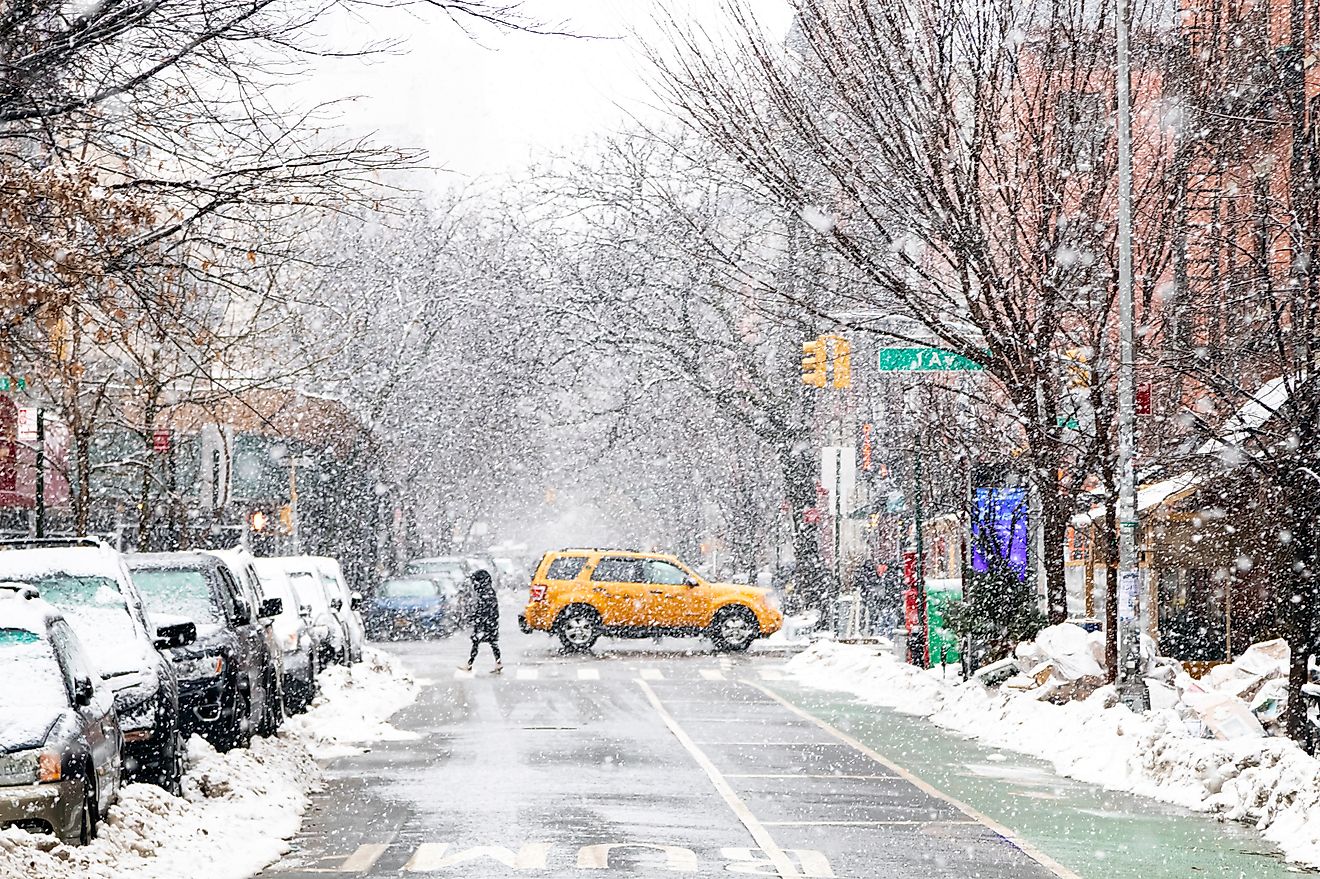 Snowy winter street scene at an intersection on 1st Avenue in the East Village of New York City NYC