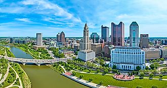 Aerial panorama Columbus Ohio with bright blue sky with clouds and bridge over Scioto river