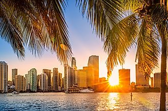 Miami, Florida skyline with sunbeams shining through the skyscrapers.