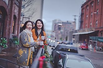 Happy asian elderly mother and adult daughter enjoying coffee at Portland pearl district outdoor cafe