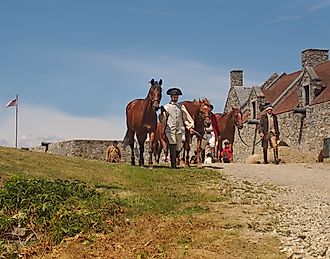 Reenactors leading horses through Fort Ticonderoga after a re-enactment