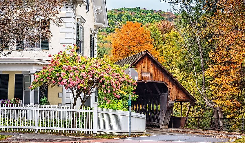 Covered bridge in Woodstock, Vermont with flowers blooming.