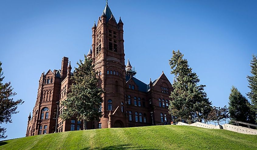 Crouse College sits atop a green grassy hill on the campus of Syracuse University in Syracuse, New York.