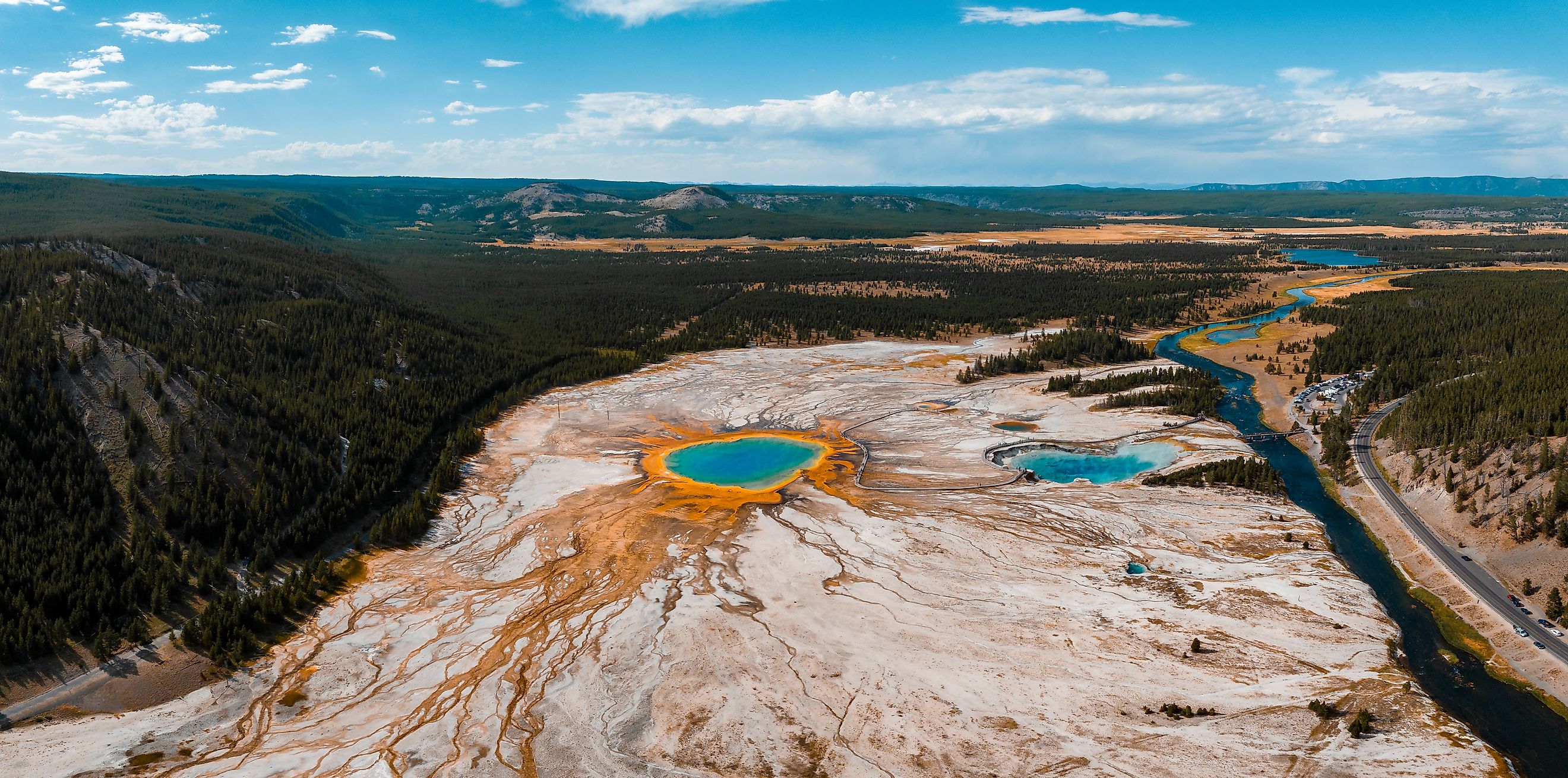 Beautiful geysers with hot water and steam with pools of thermophilic bacteria in the Upper Geyser Basin of Yellowstone National Park, Wyoming, United States.