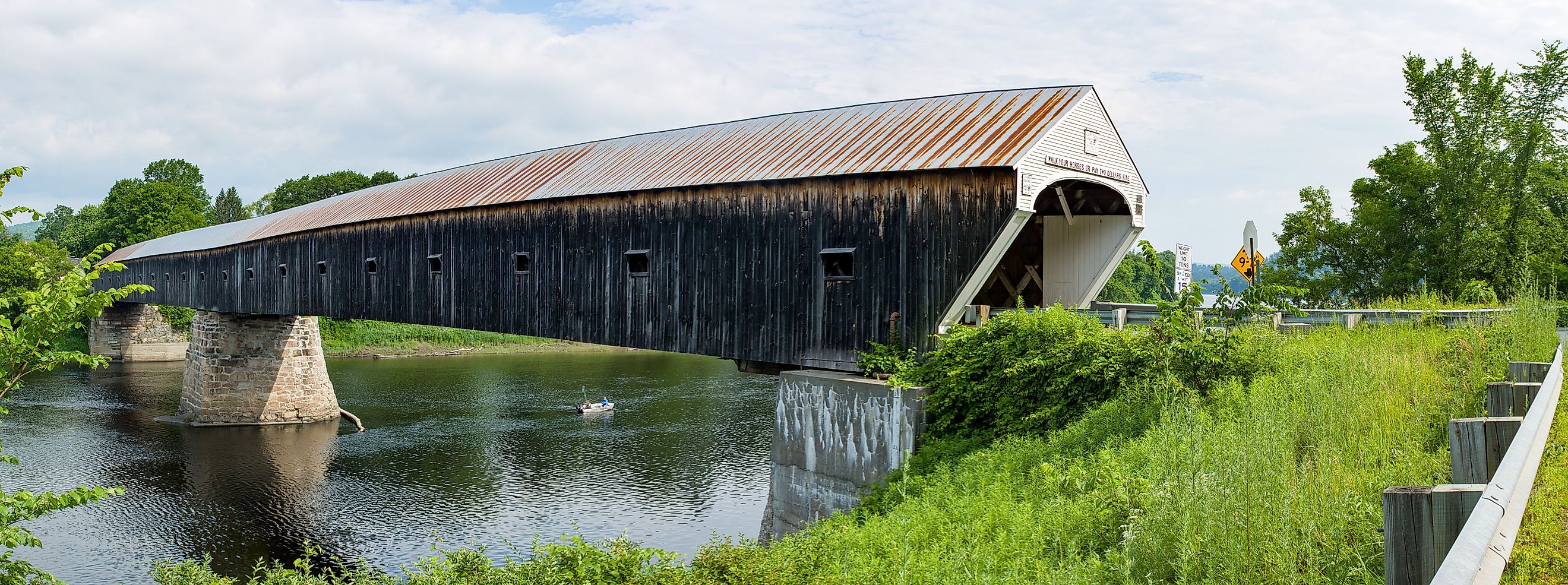 The historic Cornish Windsor Covered Bridge over the river.
