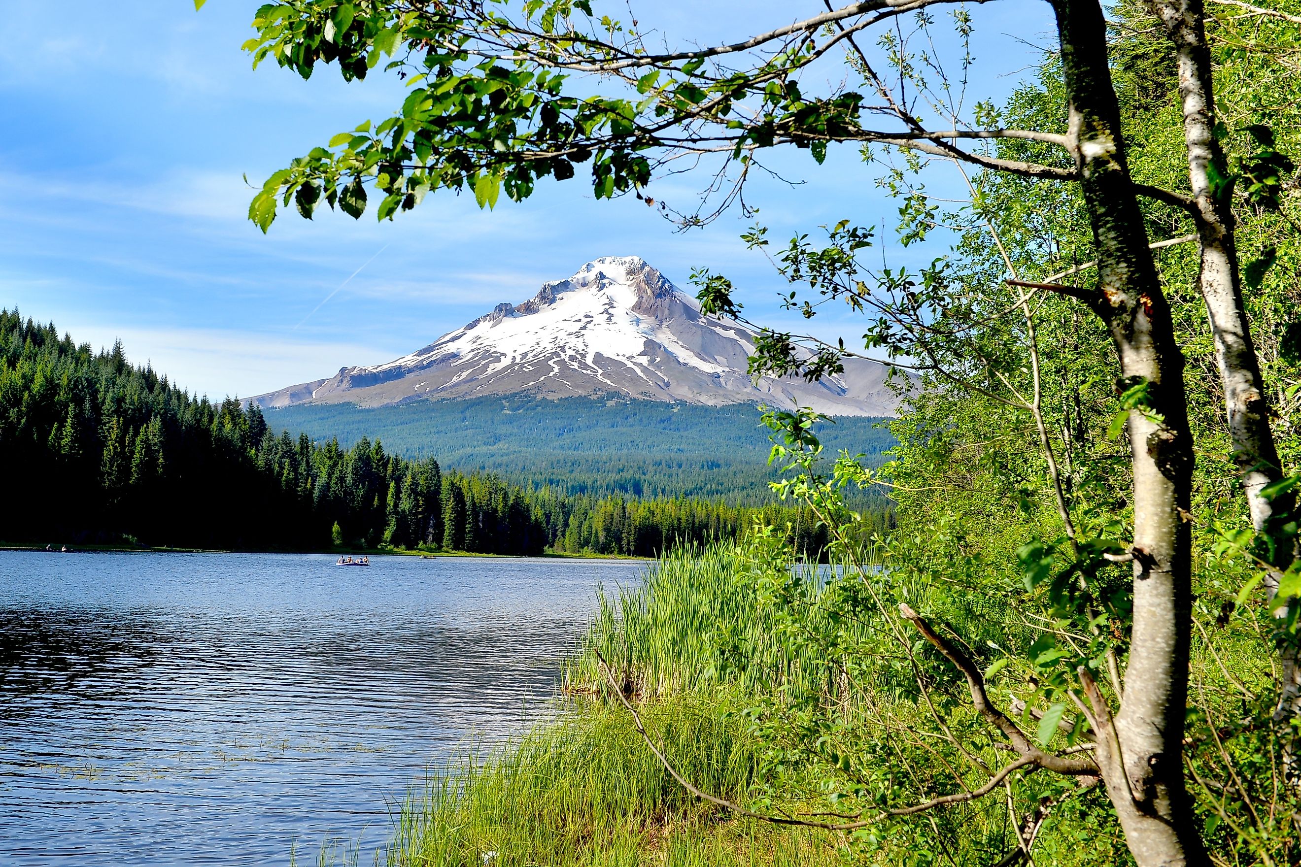 Glaciers and snowfields cover most of Mount Hood in the Mount Hood National Forest, mirror lake is near.
