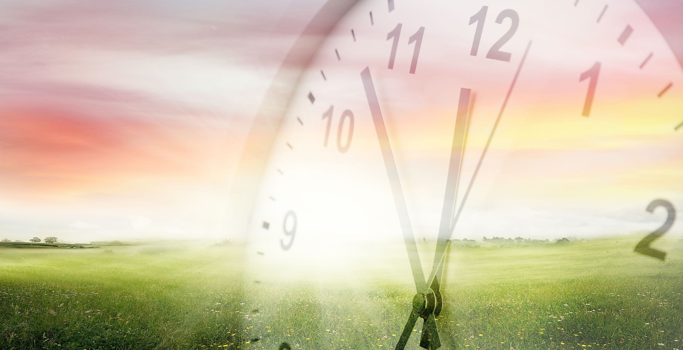 Clock, grass and sky. Spring time