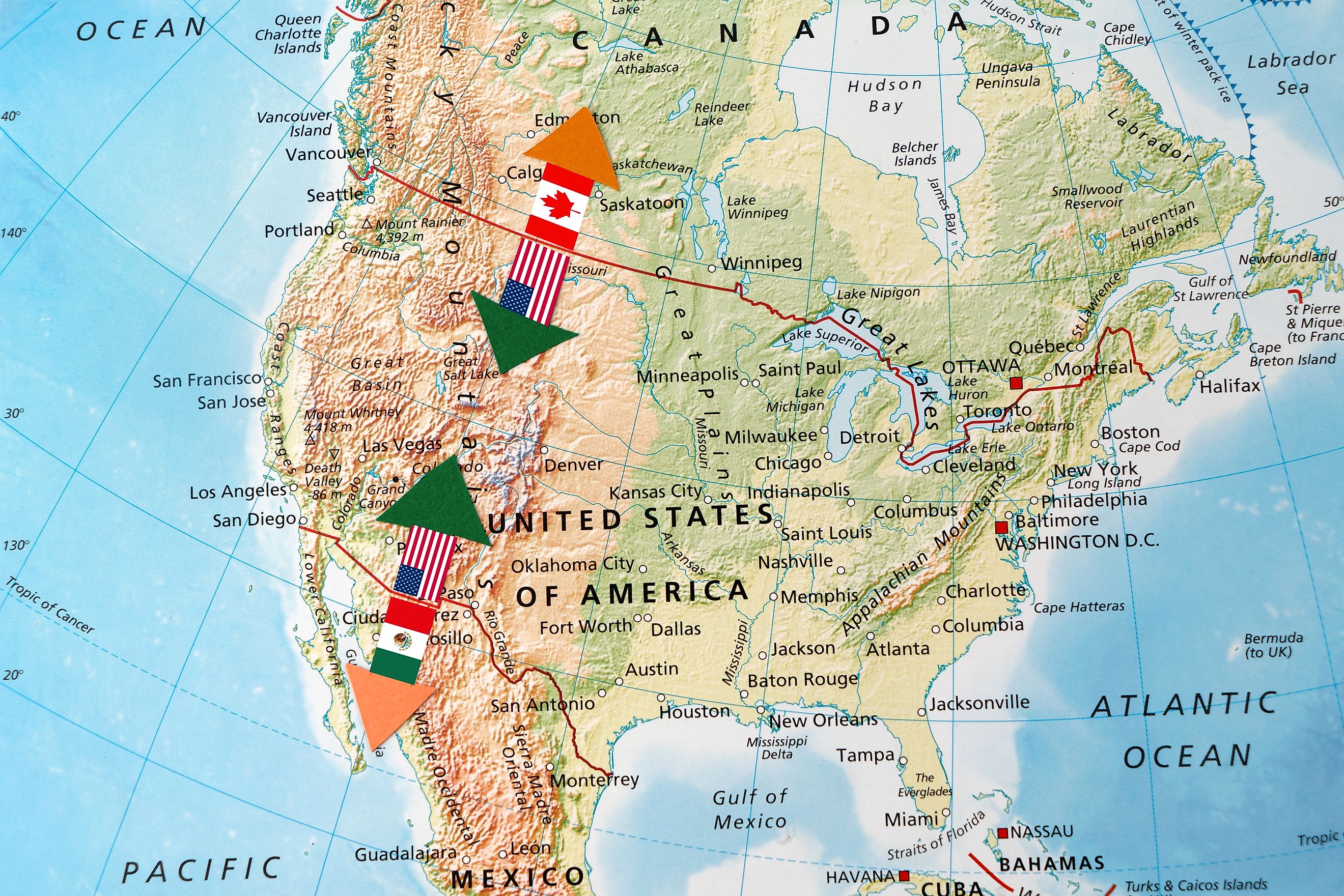 The border between the USA - Mexico and USA - Canada , accompanied by the flags of each countries