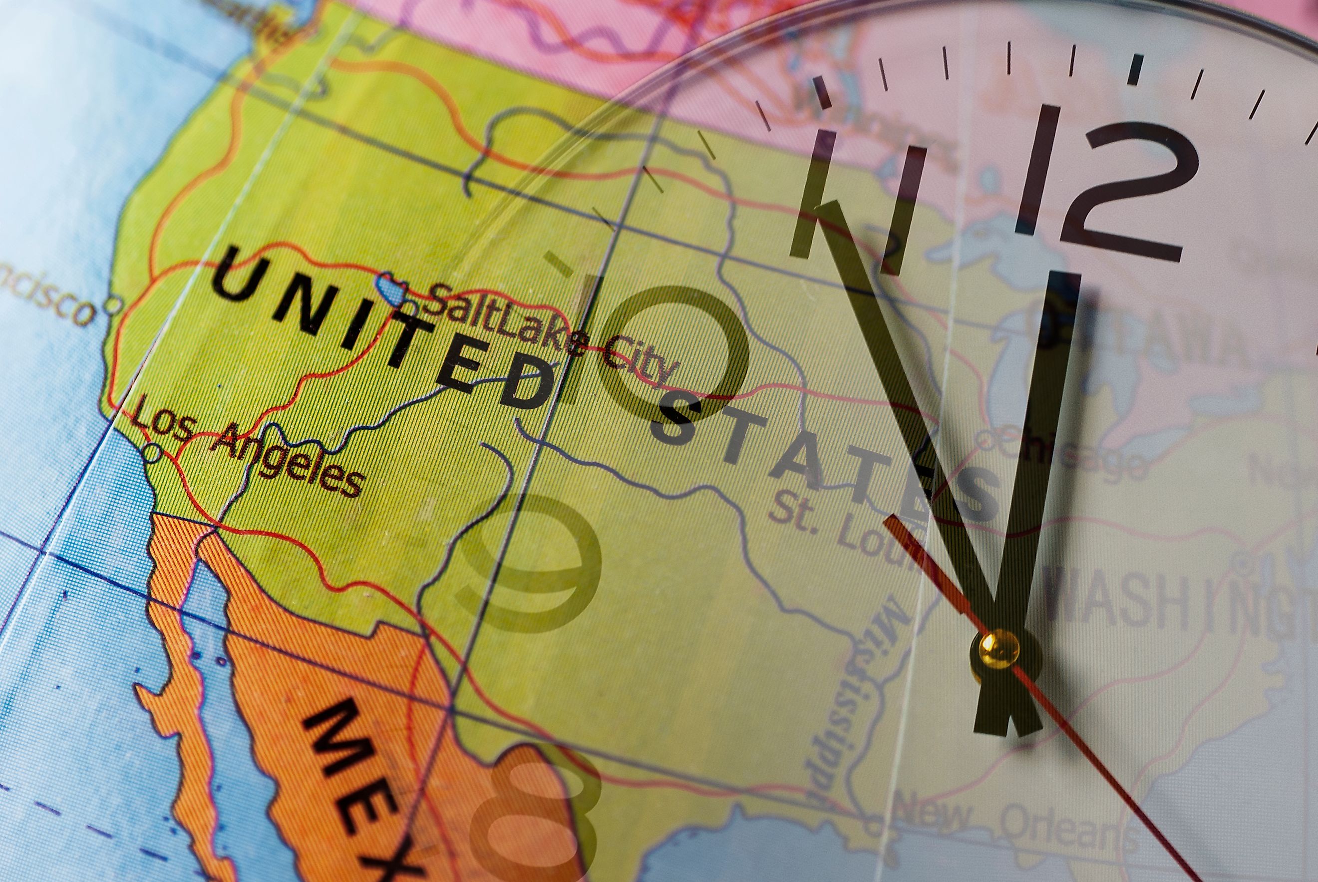 Double exposure of colorful globe with United States and clock
