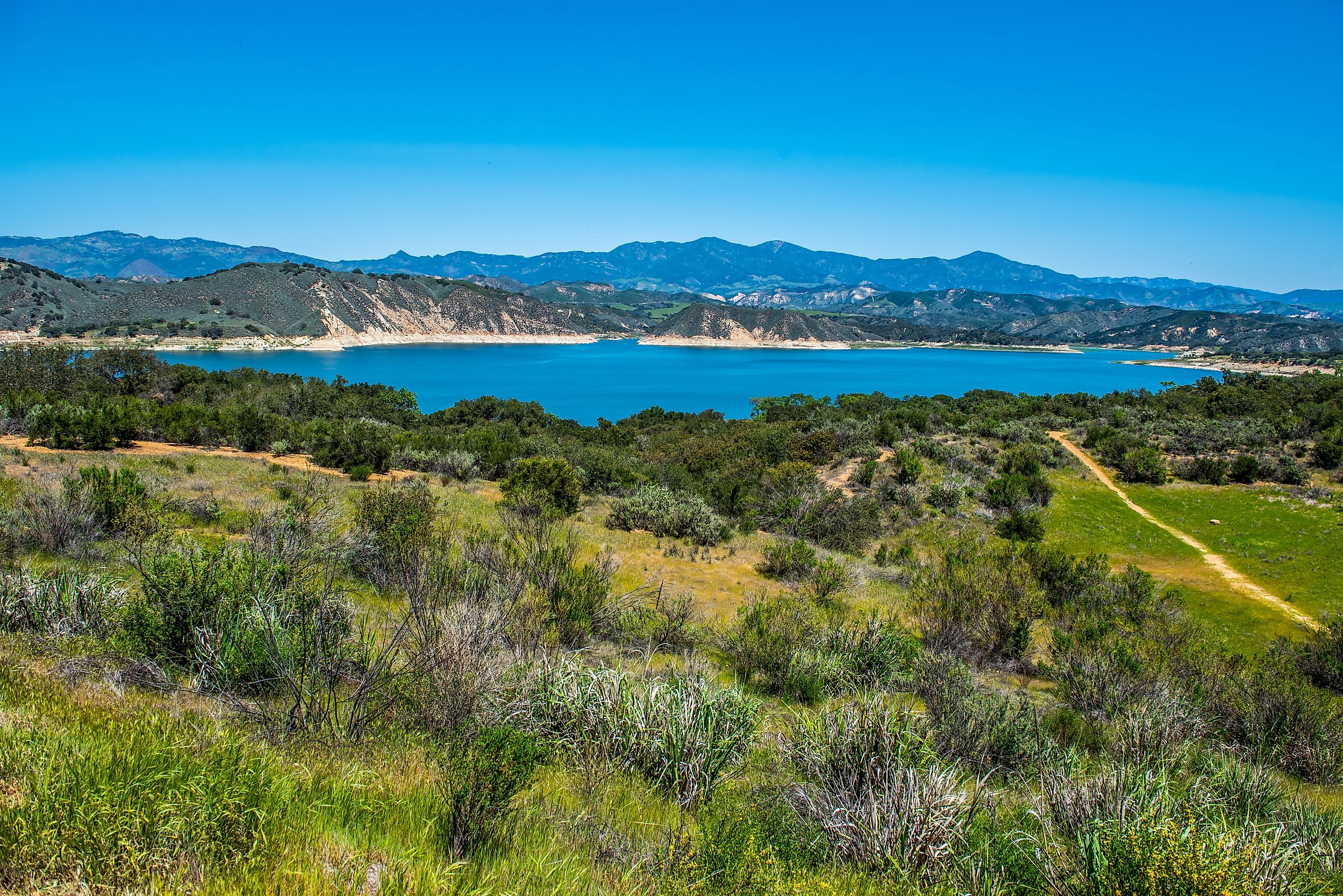 View of Lake Cachuma and the green rolling hills of Los Padres National Forest above and the Santa Ynez Valley of central Santa Barbara County, California