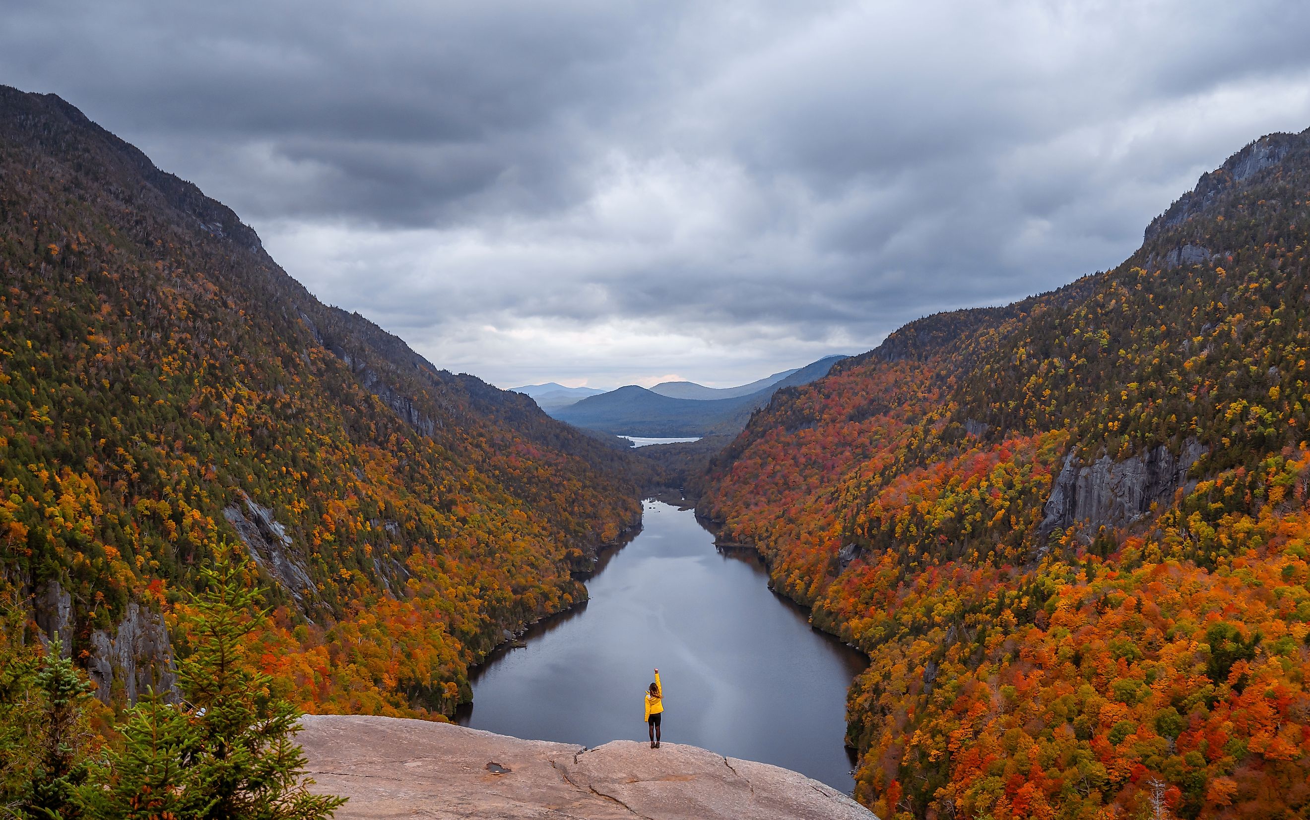 Female hiker with yellow jacket in Adirondacks 