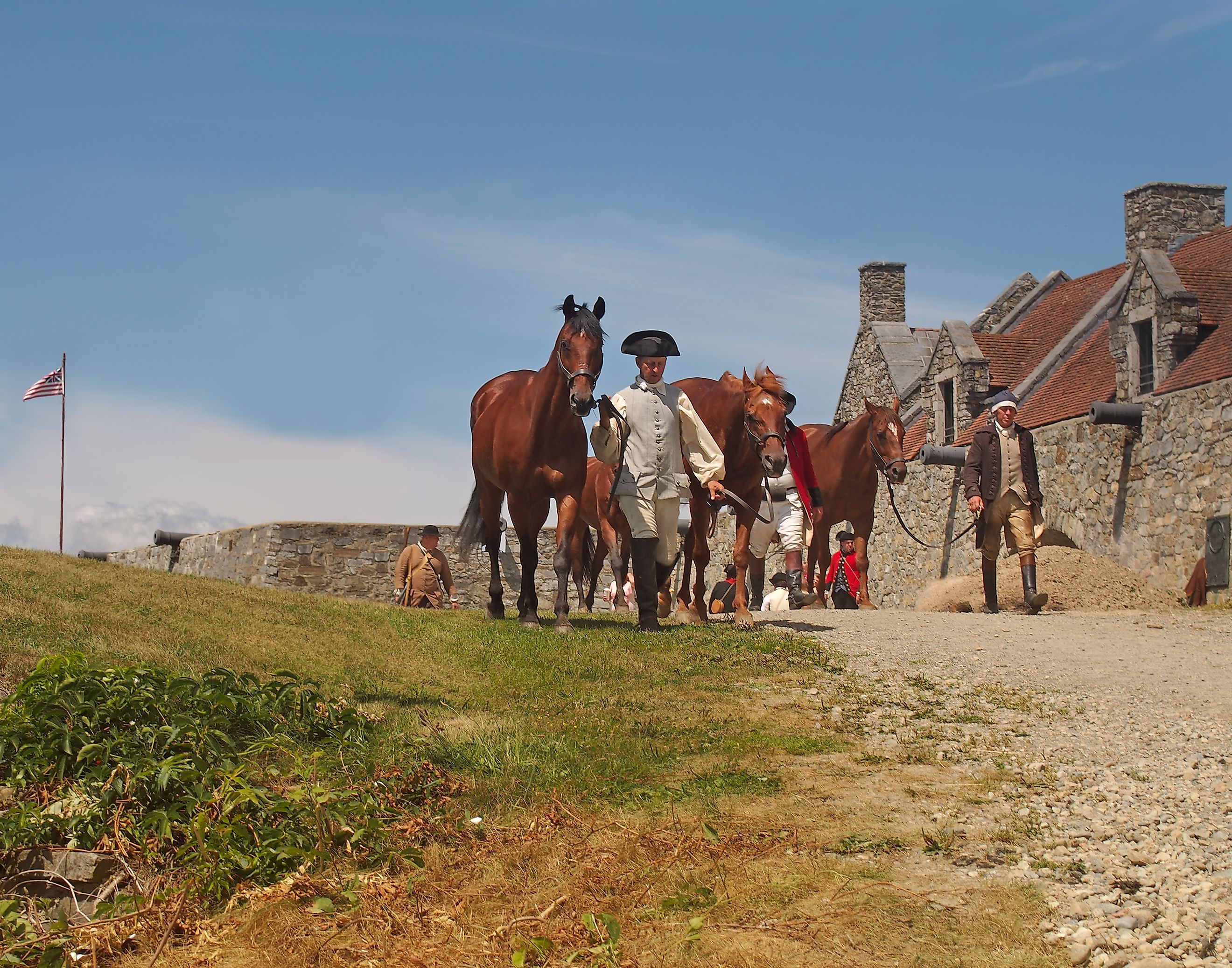 Reenactors leading horses through Fort Ticonderoga after a re-enactment